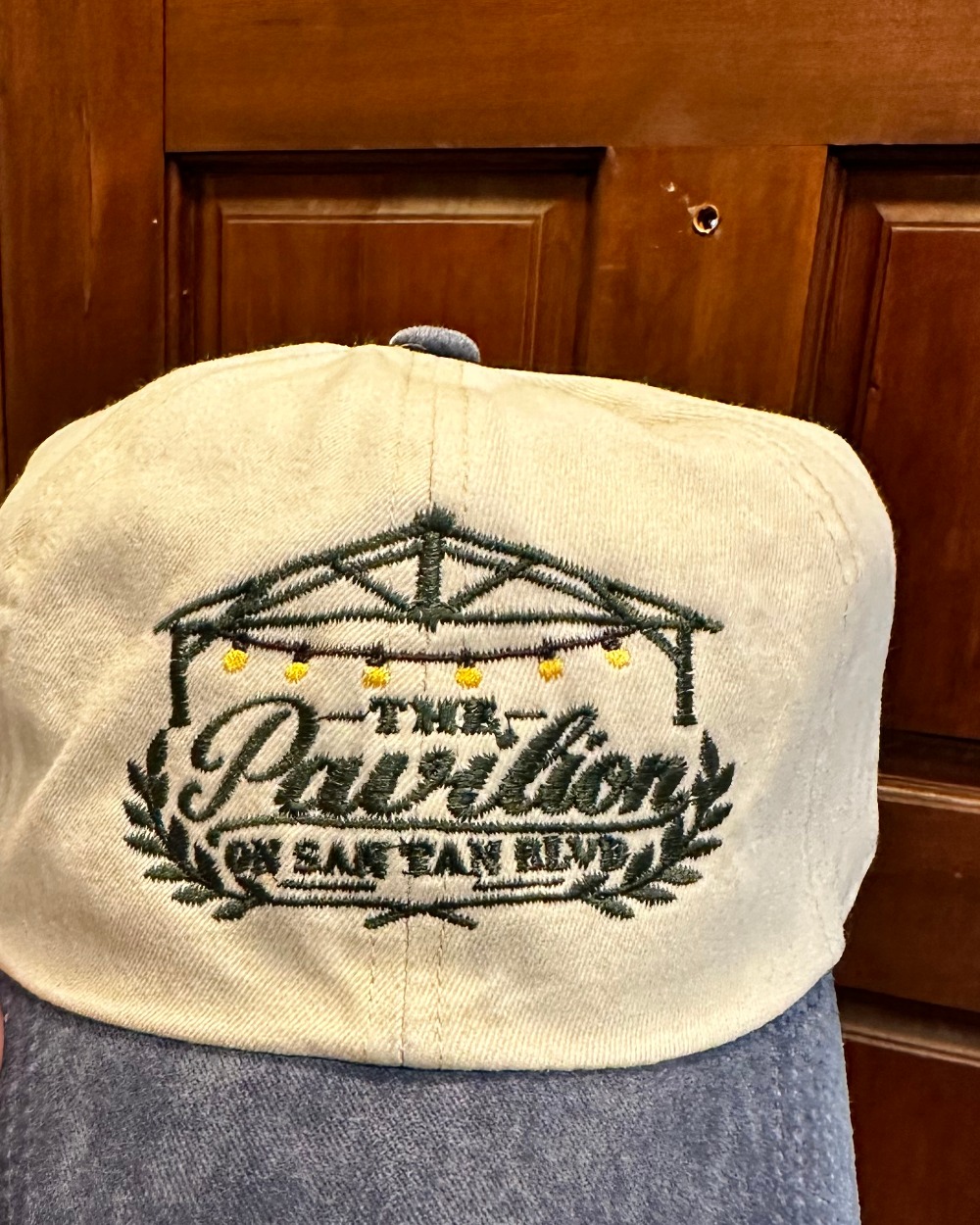 Four cream and denim caps embroidered with the LaShaw Century Farm logo